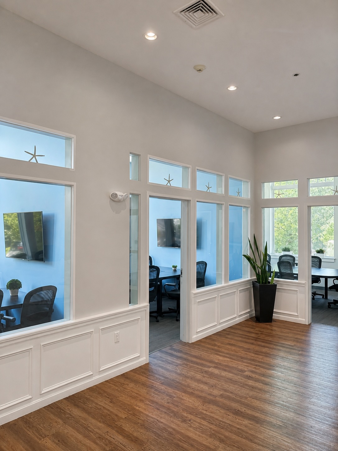 Interior foyer at Seacoast Professional Suites with glass-walled meeting rooms and soaring ceilings