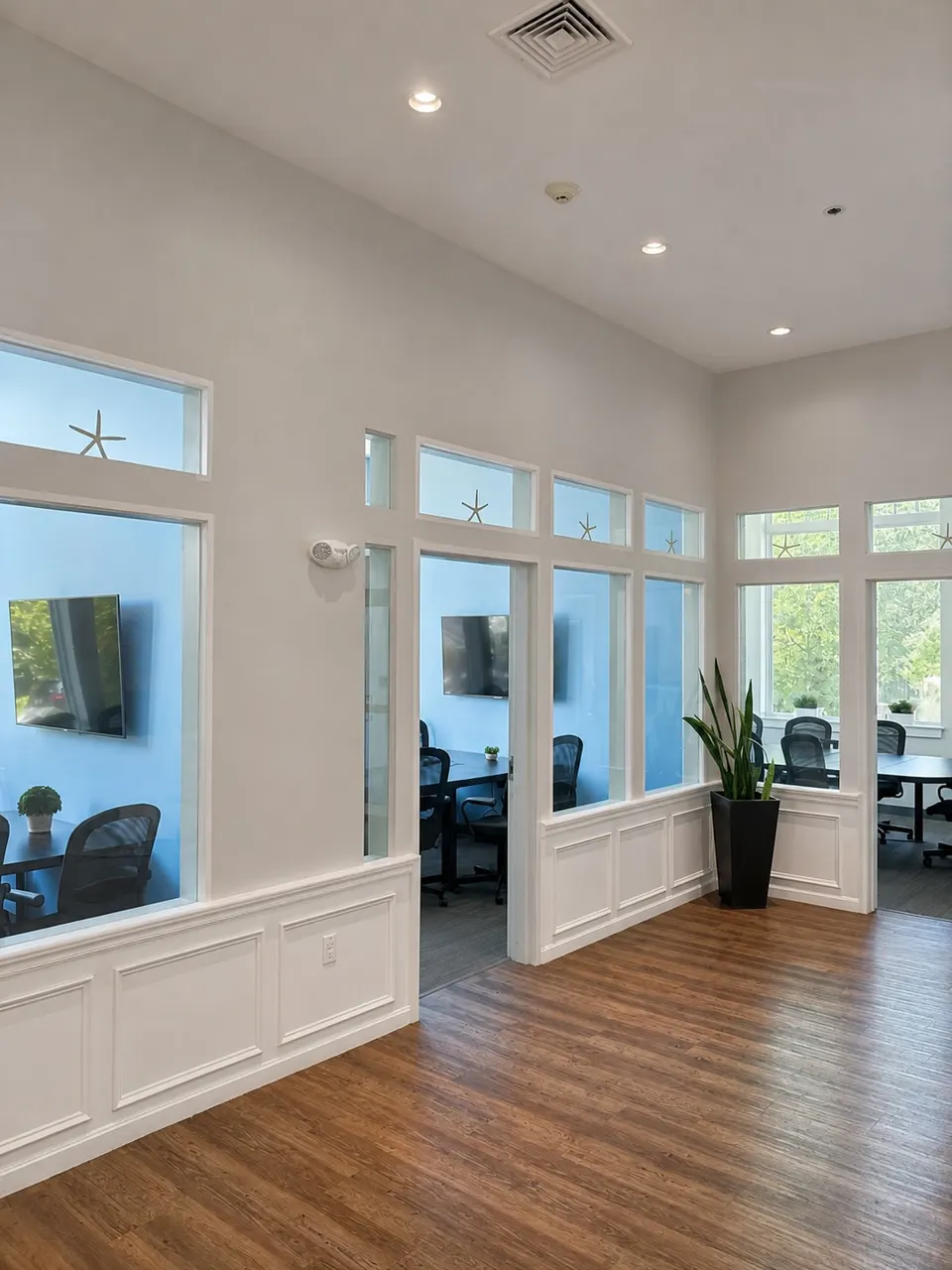 Interior foyer at Seacoast Professional Suites with glass-walled meeting rooms and soaring ceilings